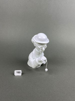 porcelain figurine of a boy with a hat and a cane