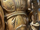 a gold statue of a man holding a sword