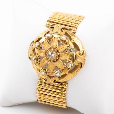 an image of a close up of a gold watch on a white napkin