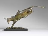 bronze sculpture of a fish on a black base on a gray background