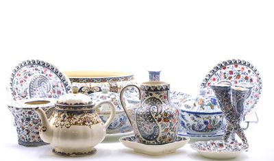 many different types of teapots and saucers on the table