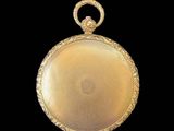 an image of a gold pocket watch on a black background