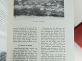 an open book with a black and white photo of a town
