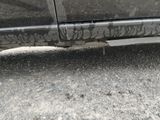 a close up of a car with graffiti on the side of it