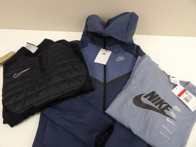 a pile of clothing on a table next to a bag