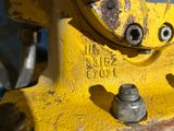 a close up of a yellow machine with nuts on it