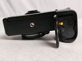 a black camera that is sitting on a white surface