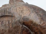 a close up of a statue of a fish on a white surface