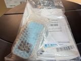 a bag of items on a motorcycle that is wrapped in plastic