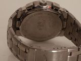 a close up of a watch on a white surface