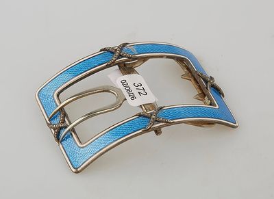 blue leather belt buckle with silver buckle on white surface