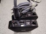 a cord connected to a power strip on the floor