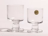 two wine glasses sitting next to each other on a table