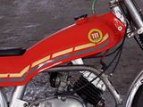 a red dirt bike parked on the side of the road