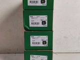 three boxes of green boxes are stacked on top of each other