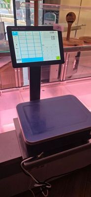 a digital scale sitting on a counter in a store