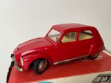 a red toy car sitting on top of a red box