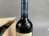 a bottle of wine sitting next to a wooden box
