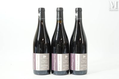 three bottles of wine sitting next to each other on a white surface