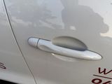 a close up of a car door handle with a sticker on it