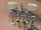 a lot of brass candles that are on a table
