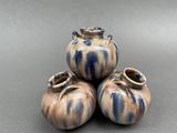 three vases sitting on top of each other on a table