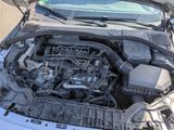 a car engine with its hood open on the street