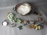 a silver bowl with a bunch of glass beads on it