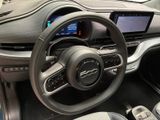 the interior of a car with a steering wheel and dashboard controls