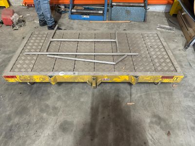 a man that is standing next to a table in a garage