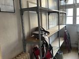 a room with a radiator, bookshelf, and other items in it