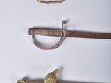 several different types of swords are displayed on a white surface