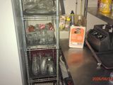 a metal rack with glasses on it in a kitchen