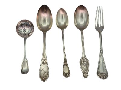 five spoons and a fork sitting next to each other