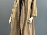an image of a mannequin wearing a tan coat and black shirt
