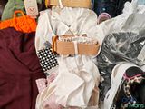 a pile of clothes and bags on the floor