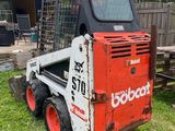a picture of a bobcat ski - loader parked in a yard
