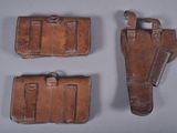 three pieces of leather are sitting on a table next to each other
