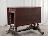an old wooden table sitting on top of a hard wood floor