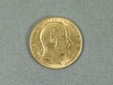 une pièce d'or sur laquelle figure l'image d'un homme