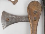 two old axes and a hammer on a white surface
