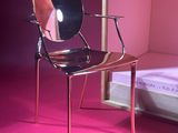 a chair that is sitting in front of a mirror