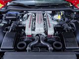 a red car engine with its hood open in the grass