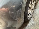 a close up of a car ' s front bumper with a denting on it