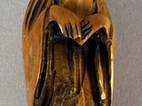a statue of a woman holding a cat on her lap