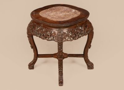 an old wooden table with a marble top on a beige background