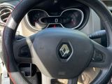 the steering wheel of a small car with a red stitching on it