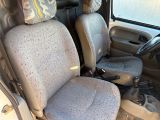 two seats in the back of a van that is dirty