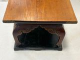 a wooden table with a black base and a brown top