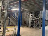 an image of a large warehouse with a lot of equipment